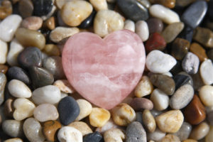 Rose quartz heart on stones