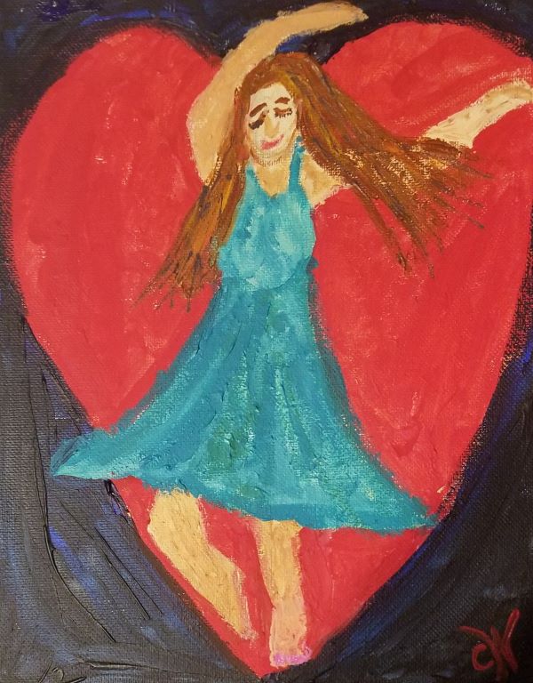 Woman in turquoise dress dancing in front of heart paiting